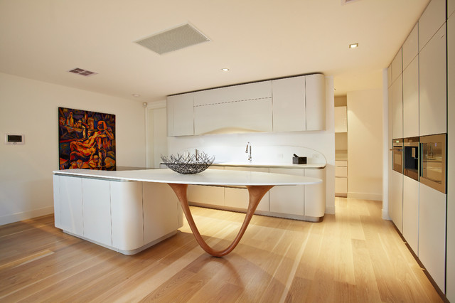 A modern kitchen with a wooden island.