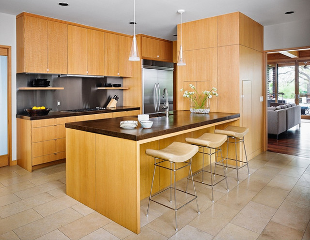 Modern kitchen featuring wooden cabinets and countertops with a kitchen island.