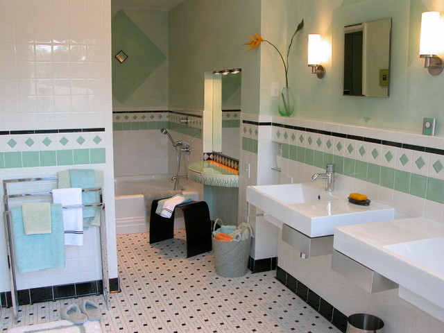 A bathroom with green and white tile and a sink showcasing tile ideas.