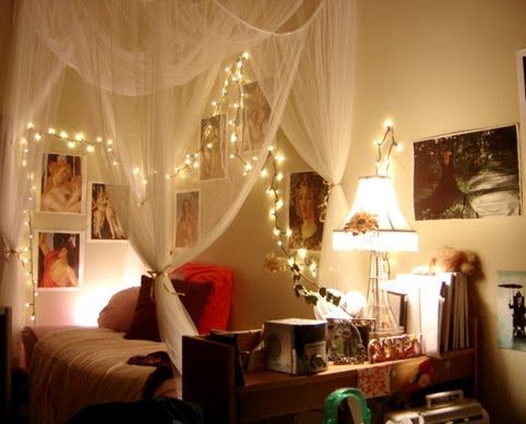 A bedroom adorned with fairy lights and pictures.