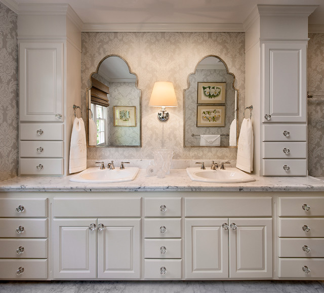 A bathroom with white cabinets, marble counter tops, and mirror ideas.