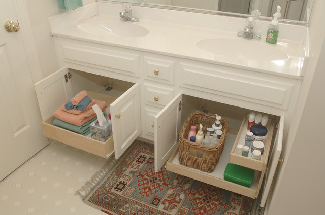 A bathroom with two sinks and ample storage space.