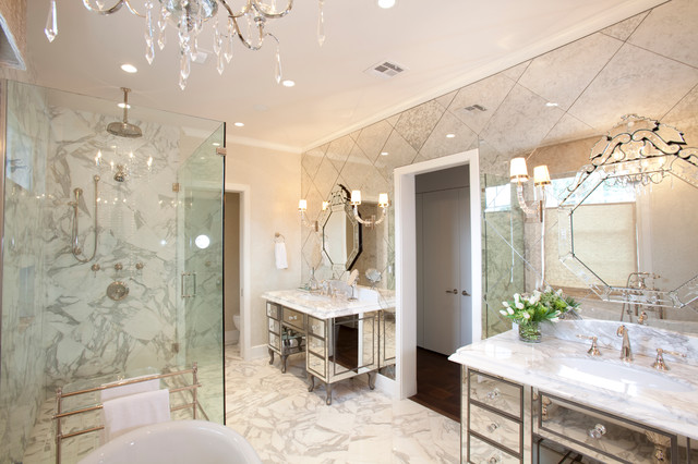 A bathroom with decorative mirrors and a chandelier.