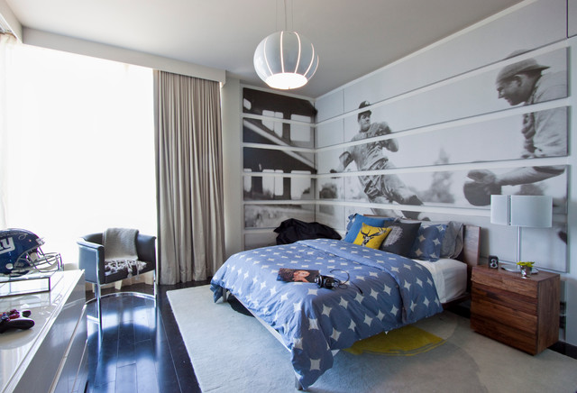 A bedroom with a bed and a bedside table, featuring wall decoration.