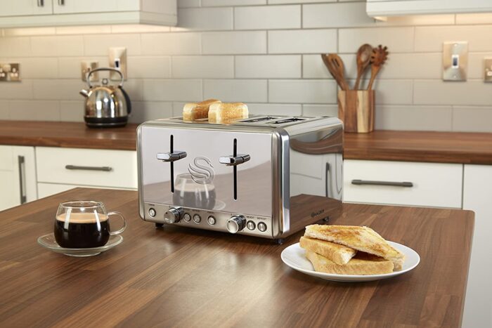 A romantic breakfast with a silver toaster on a kitchen counter.