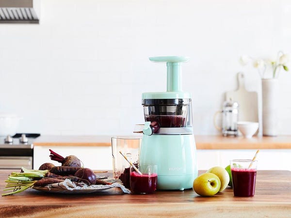 A juicer is sitting on a kitchen counter for a romantic breakfast.