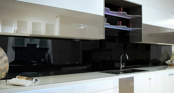 A kitchen with glass cabinet doors and a white counter top.