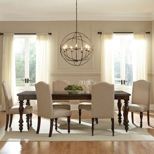 A dining room with indoor lighting, a beige table and chairs.