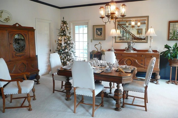 Dining room decorating ideas with white furniture and a Christmas tree.