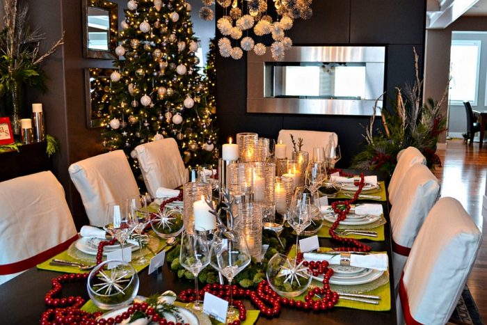 A festive dining room with a Christmas tree and candles, showcasing creative dining room decorating ideas.