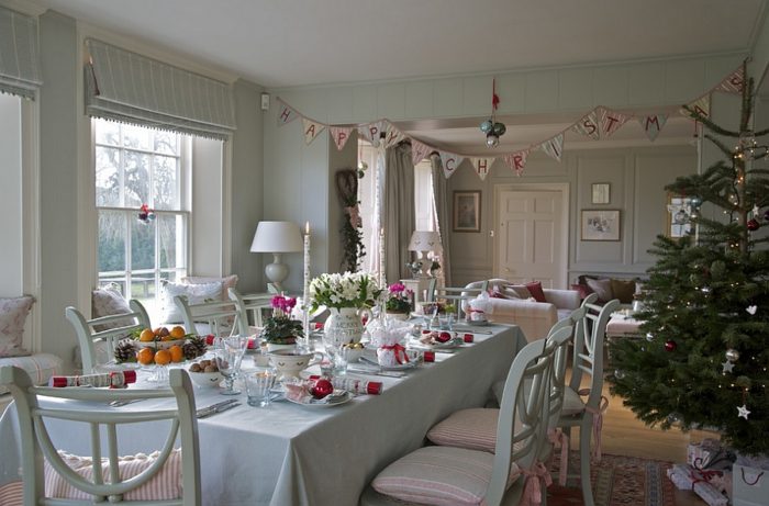 A festive dining room with a Christmas tree and decorations, perfect for dining room decorating ideas.