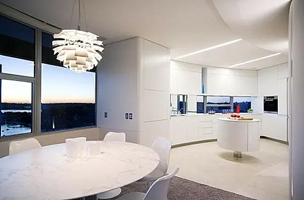 A modern dining room with a white table.