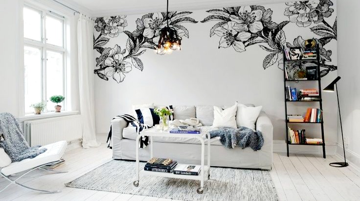 A white living room with black and white floral wall art, perfect for painting ideas.