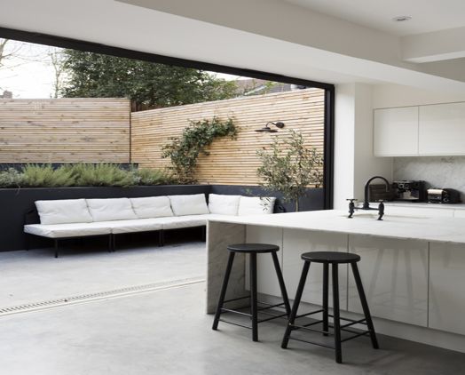 A black and white kitchen with a sliding glass door.