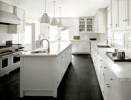 A black and white kitchen with white cabinets.
