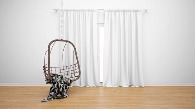 A swing chair in an empty room with white curtains that adds Zen to your home.