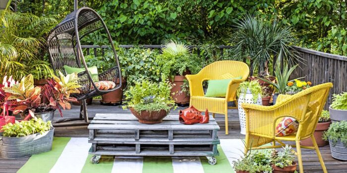 Cozy backyard with colorful furniture and plants on a wooden deck.