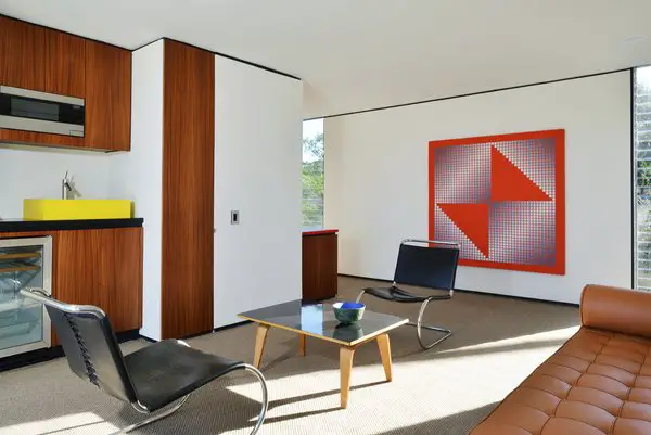 A modern living room showcasing a large painting, increasing the value of the real estate rental property.