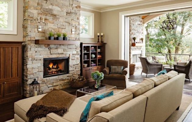 A cozy living room with a stone fireplace for keeping it warm.