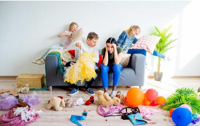 A group of people working through an overwhelming mess in a messy living room.