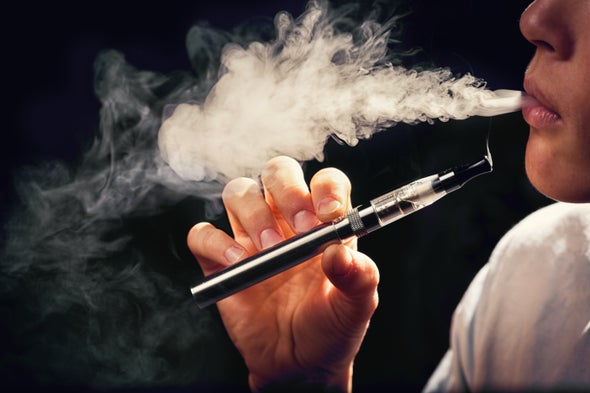 A person vaping an electronic cigarette.