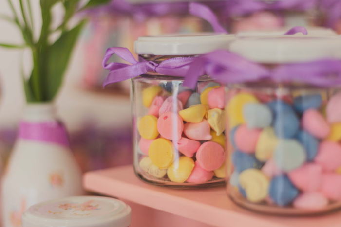 Jars of luxury candy on a shelf.
