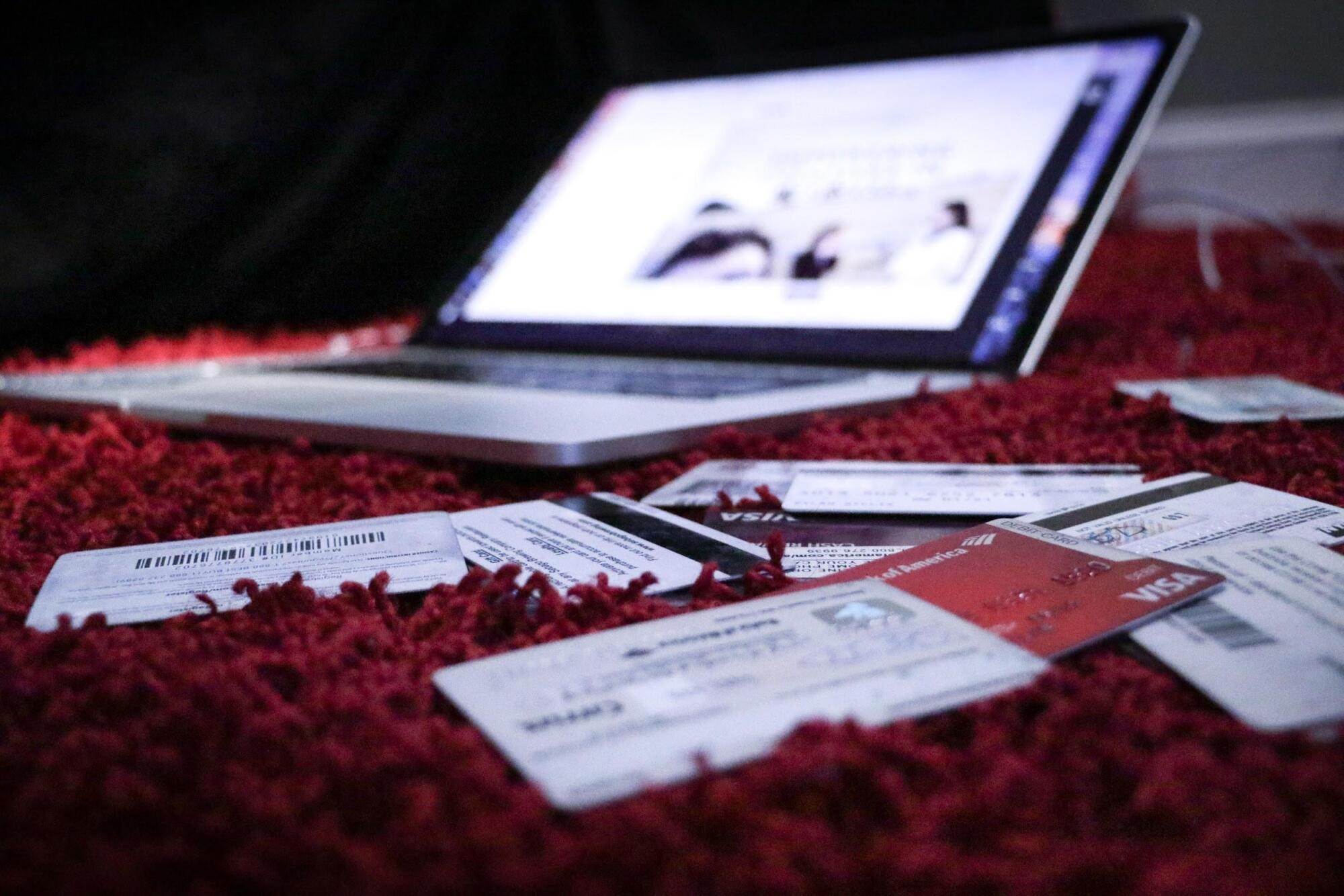 A laptop is sitting on a carpet with tickets on it, providing helpful guidance for renting an apartment with troubled credit.