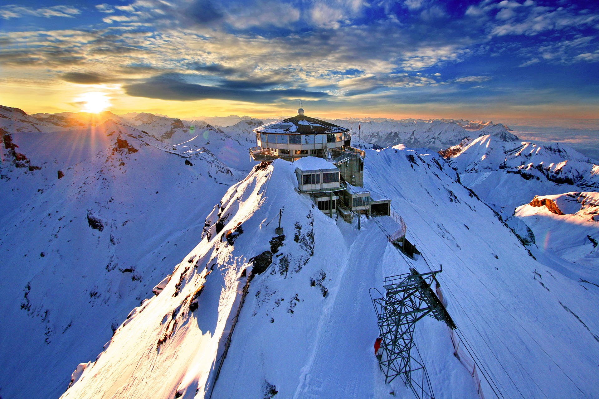 A building on top of a snow covered mountain with energy cost down in the winter.