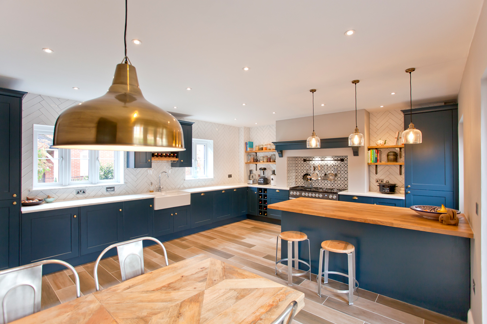 A kitchen with blue cabinets and a wooden table in Oxfordshire.