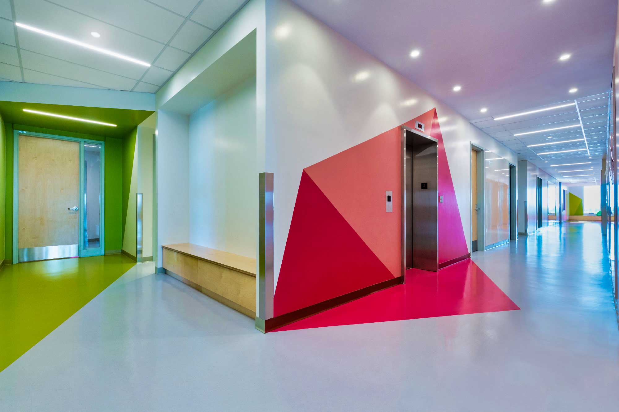 A brightly colored hallway in a hospital featuring Artigo Rubber Flooring.