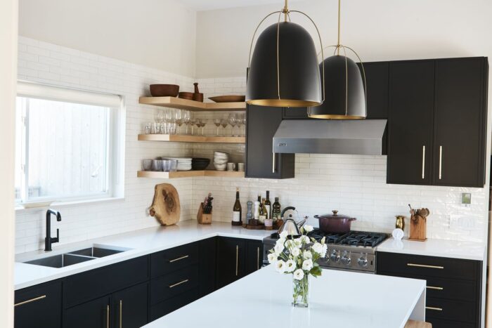 A modern kitchen with black cabinets.