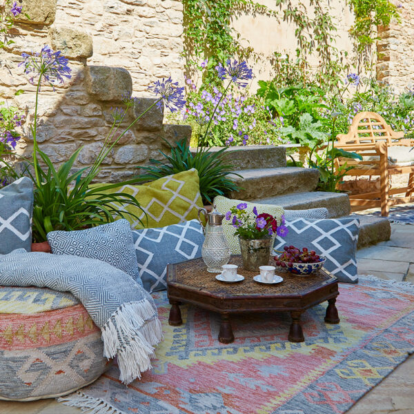 Budget-friendly patio furniture with a table, chairs, and a rug.