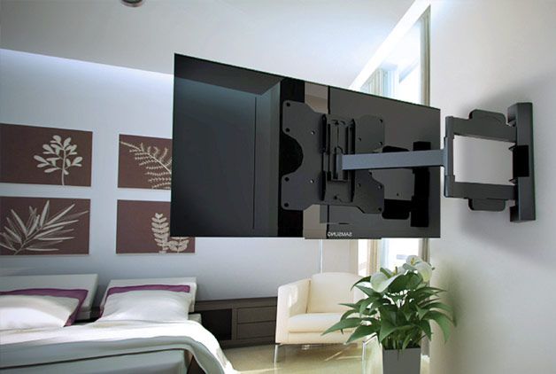 A mounted TV in a bedroom.