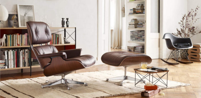 The eames lounge chair and ottoman are in a living room, enhancing the home decor.