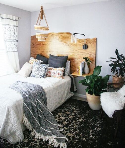A boho bedroom with a bed and a bedside table.