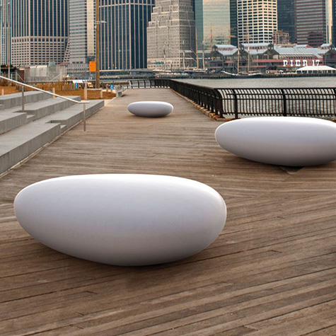 A group of white spheres on a wooden boardwalk, perfect for your garden.
