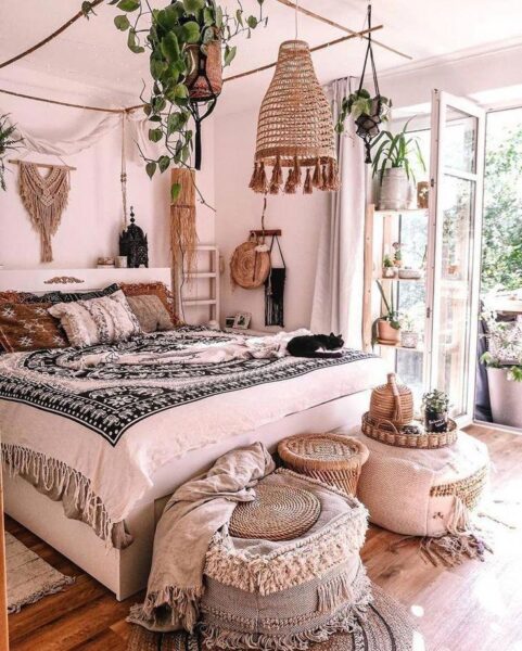 A bohemian bedroom with a bed and a bedside table, featuring a boho vibe.