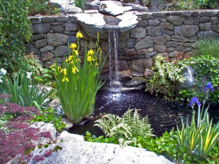 Landscaping a garden with a pond and waterfall.