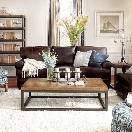 A home decor featuring a brown leather living room with blue accents.