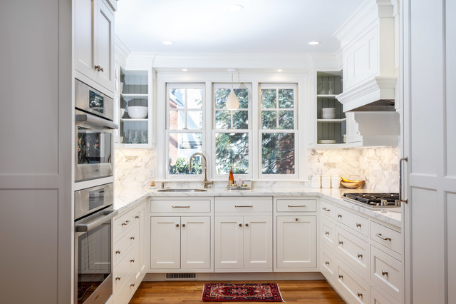 A kitchen with white cabinets and a rug designed for modern aesthetics.