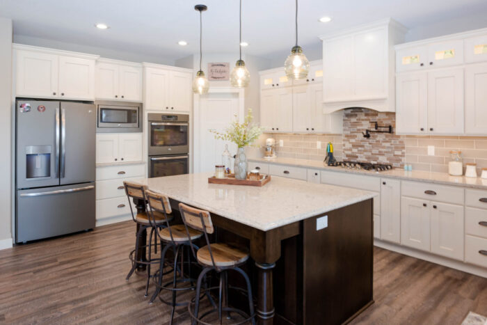 Design a kitchen with white cabinets and a center island.