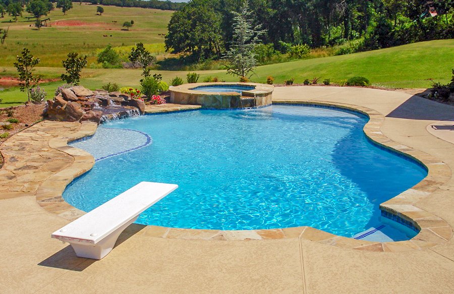 A backyard pool with a waterfall feature.