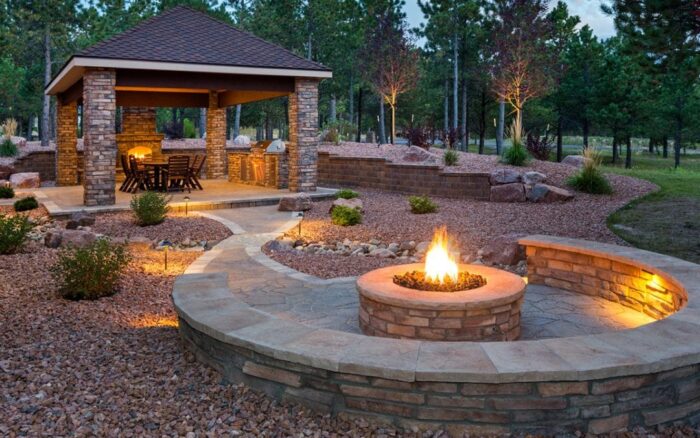 Renovation: A renovated gazebo with a fire pit in the middle of the yard.