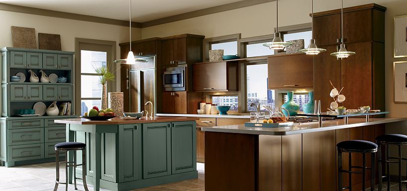 A kitchen with unique dark wood cabinets and a center island.