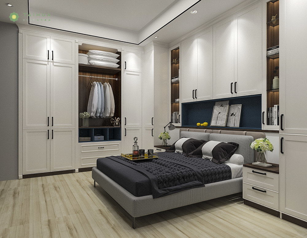 A bedroom with white cabinets and a bed.