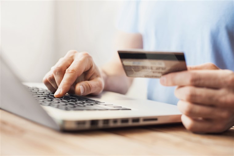 A person buying online with a credit card.