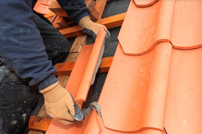 A man is restoring an old roof.