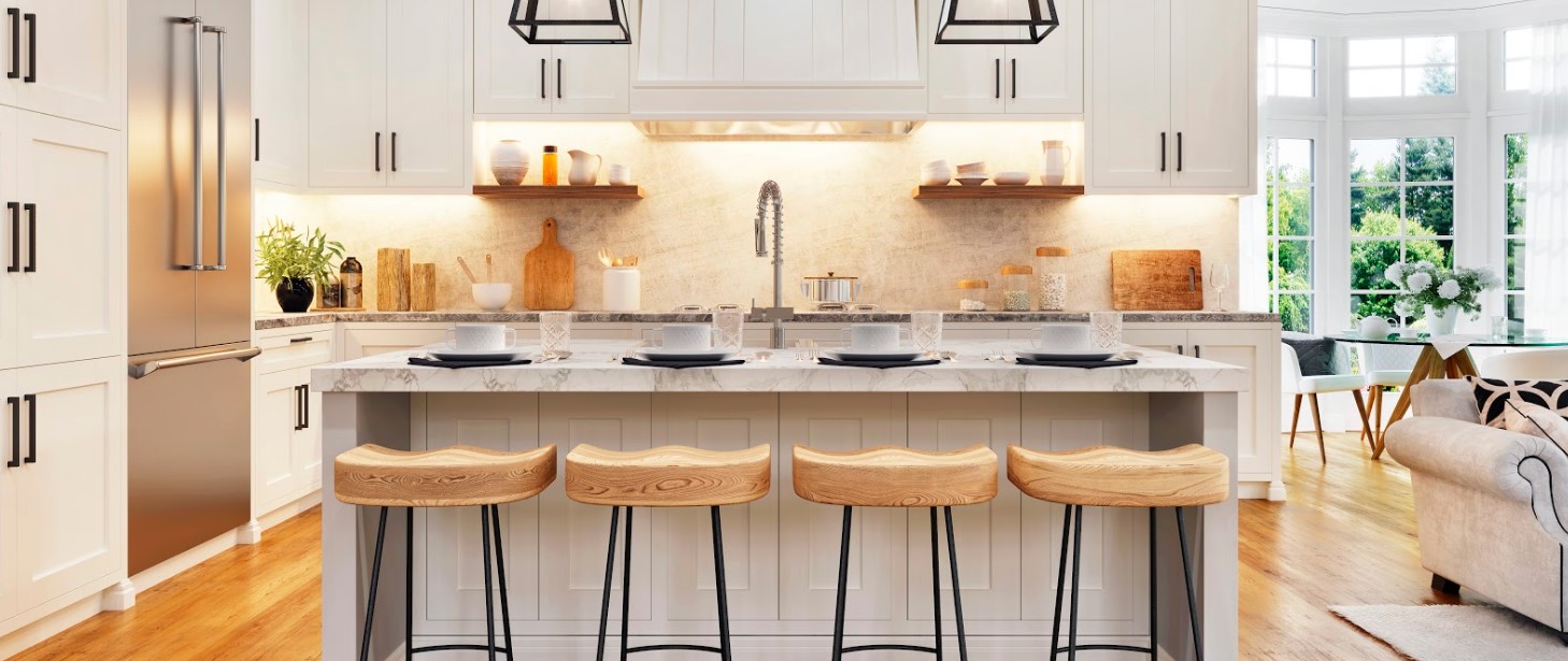 A white kitchen with a center island and wooden stools, featuring upgrades that will revolutionize your space.