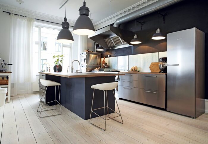 A modern kitchen design with stainless steel appliances.