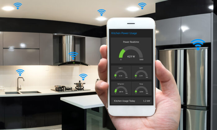 A person holding a smart phone in front of a kitchen for Kitchen Design inspiration.